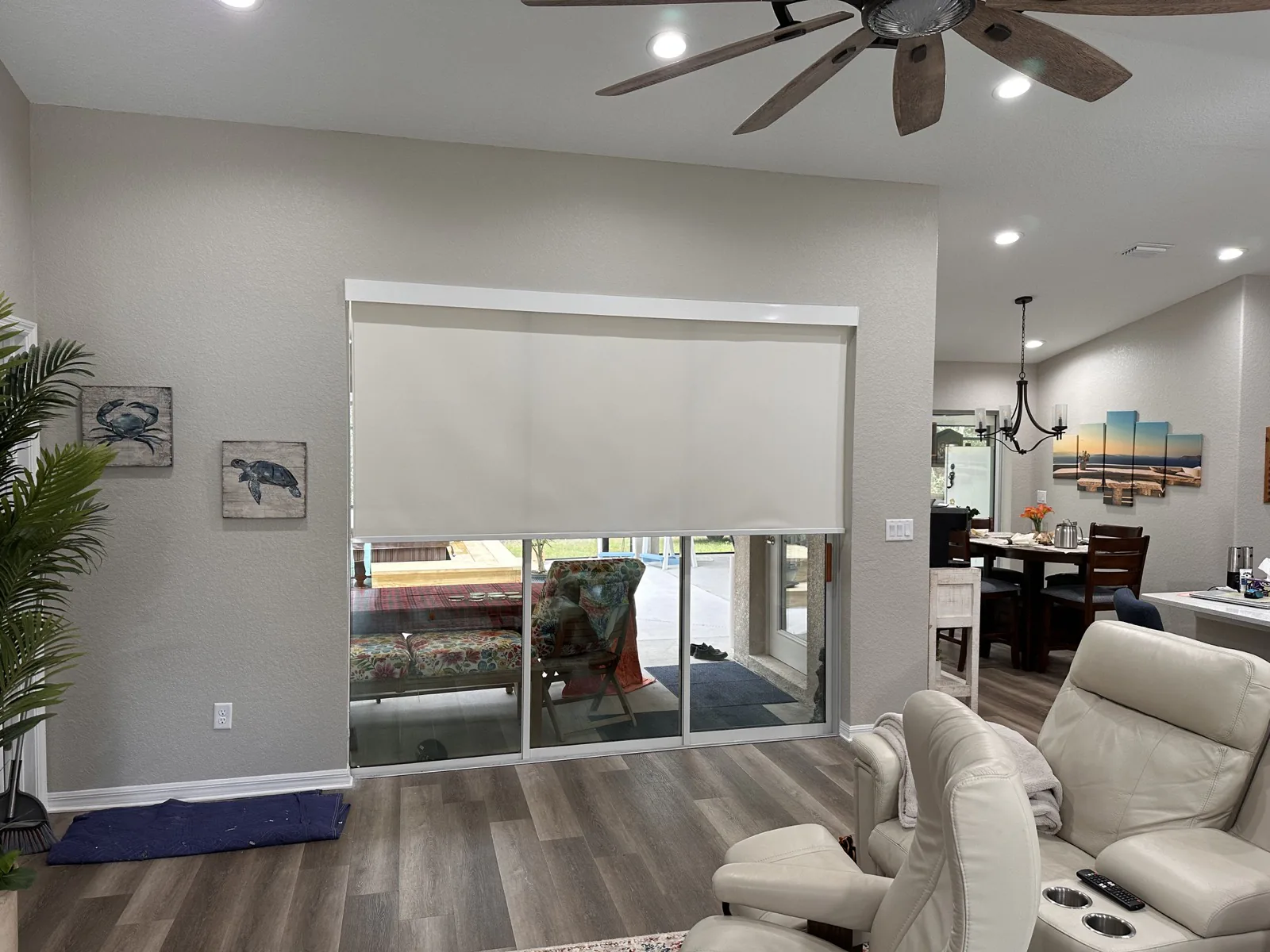Custom roller shade fitted over a wide sliding glass door